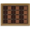 Turkish madlen chocolates from above: rows of square milk and dark chocolates in the gold box