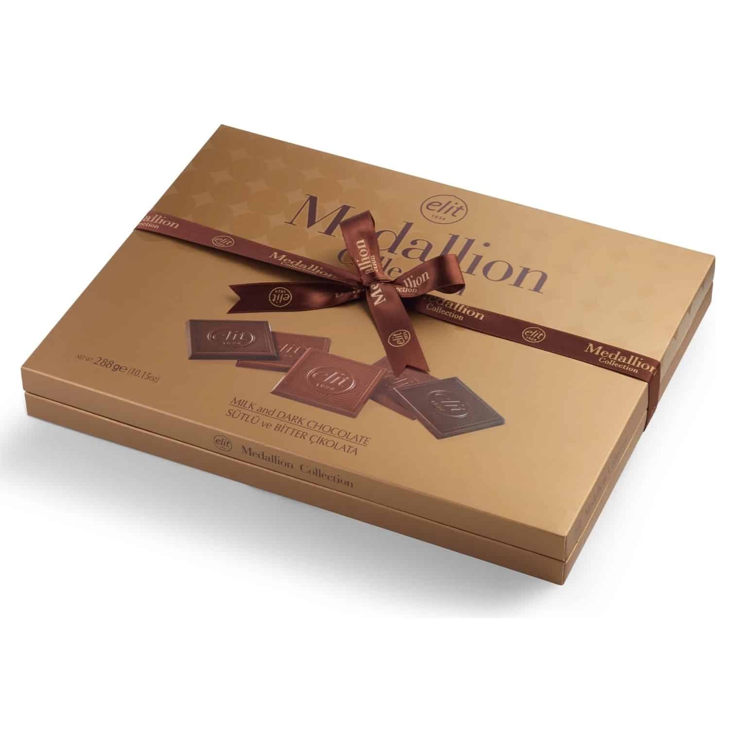 Turkish madlen chocolate gift box closed, gold box tied with a brown ribbon, side view