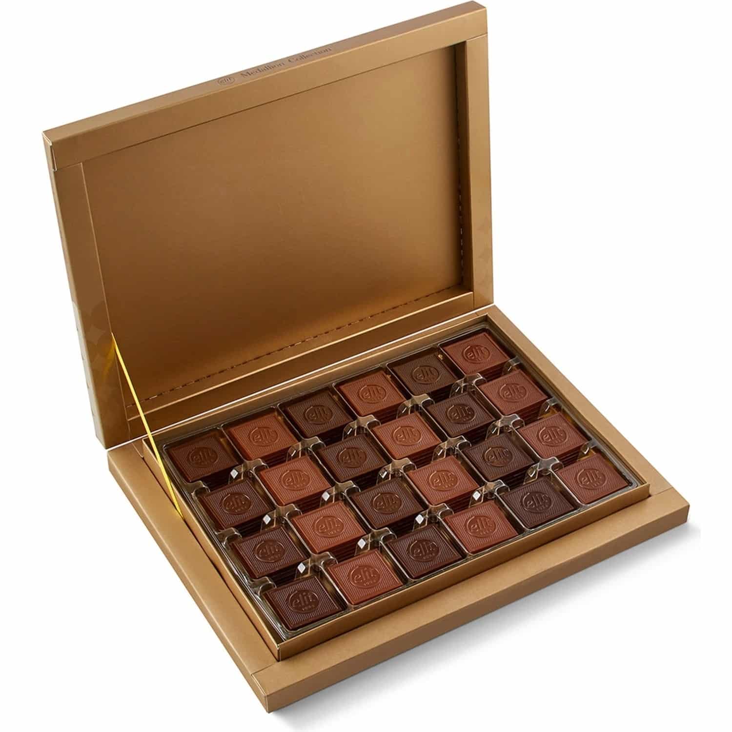 Turkish madlen chocolate gift box opened, with square milk and dark chocolates in a gold tray